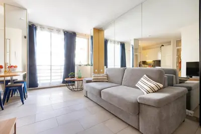 a living room with a couch and a table at 45 Croisette Apartment - Prime Location - Beach & Palais by Foot - AC in Cannes
