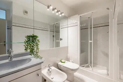 a bathroom with a sink and a toilet and a shower at 45 Croisette Apartment - Prime Location - Beach & Palais by Foot - AC in Cannes