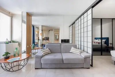 a living room with a couch and a table at 45 Croisette Apartment - Prime Location - Beach & Palais by Foot - AC in Cannes