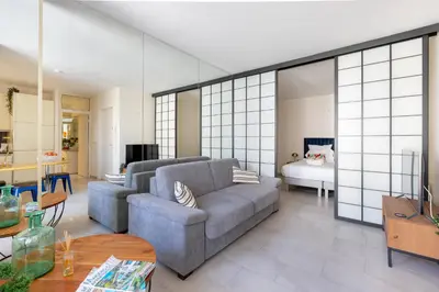 a living room with a couch and a bedroom at 45 Croisette Apartment - Prime Location - Beach & Palais by Foot - AC in Cannes