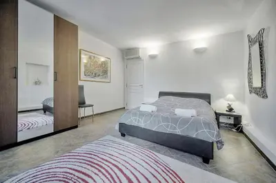 a bedroom with a bed and a mirror at Joli 3 chambres MEYNADIER-FORVILLE A3B075 in Cannes