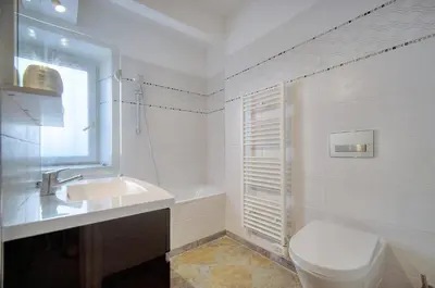 a white bathroom with a toilet and a sink at Joli 3 chambres MEYNADIER-FORVILLE A3B075 in Cannes