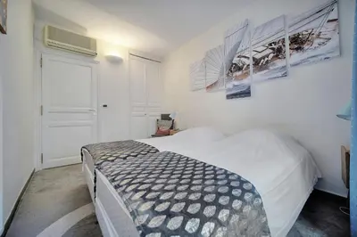 a bedroom with a bed and posters on the wall at Joli 3 chambres MEYNADIER-FORVILLE A3B075 in Cannes