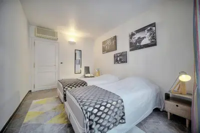 a hotel room with two beds and a door at Joli 3 chambres MEYNADIER-FORVILLE A3B075 in Cannes