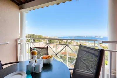 a table with a bowl of fruit on top of a balcony at Résidence Cannes Villa Francia - maeva Home - Appartement 2 pièces 4 personnes - Budget MAE-8884 in Cannes