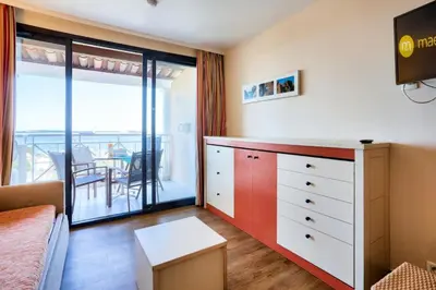 a bedroom with a dresser and a balcony at Résidence Cannes Villa Francia - maeva Home - Appartement 2 pièces 4 personnes - Budget MAE-8884 in Cannes