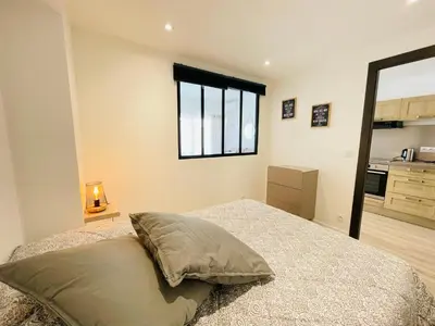 a bedroom with a bed and a window at La Suquetane in Cannes