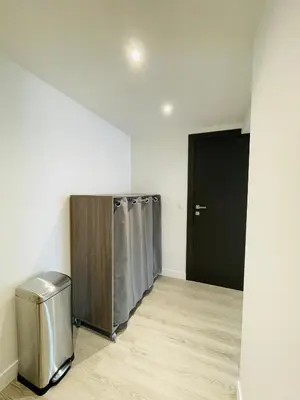 a laundry room with a black door and a silver trashcan at La Suquetane in Cannes