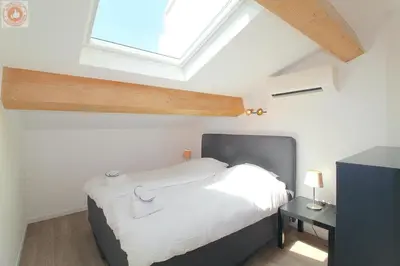 a bedroom with a bed and a skylight at ALC - MONT8 - 8 min Palais and Beaches in Cannes