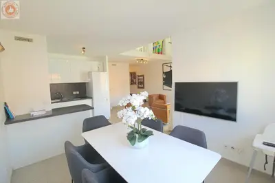 a white table with a vase of flowers on it at ALC - MONT8 - 8 min Palais and Beaches in Cannes