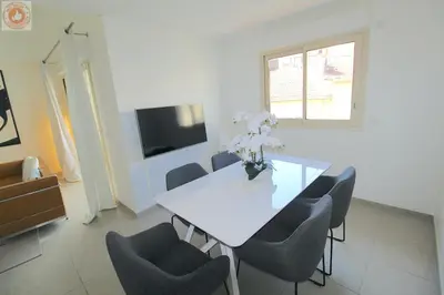 a dining room with a white table and chairs at ALC - MONT8 - 8 min Palais and Beaches in Cannes
