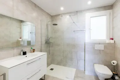 a bathroom with a toilet and a sink and a shower at Palais des Iles YourHostHelper in Cannes