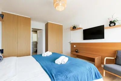 a hotel room with a bed with two towels at Palais des Iles YourHostHelper in Cannes