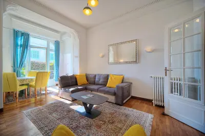 a living room with a couch and a table at IMMOGROOM -Terrace with garden - Quiet - Air-conditioner in Cannes