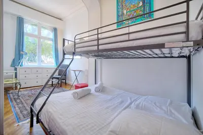 a bedroom with two bunk beds and a ladder at IMMOGROOM -Terrace with garden - Quiet - Air-conditioner in Cannes