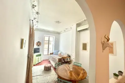 a living room with a table and a couch at Great studio in the heart of Cannes Meynadier old city neighbourhood ! in Cannes