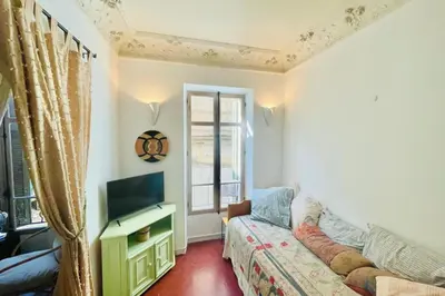 a living room with a couch and a tv at Great studio in the heart of Cannes Meynadier old city neighbourhood ! in Cannes