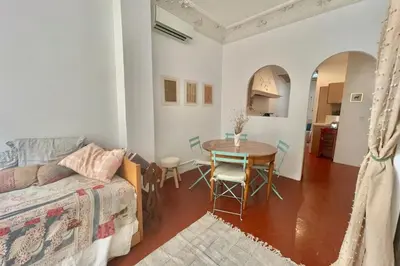 a living room with a table and a couch at Great studio in the heart of Cannes Meynadier old city neighbourhood ! in Cannes
