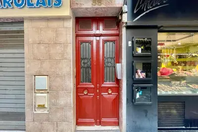 a red door on the side of a store at Great studio in the heart of Cannes Meynadier old city neighbourhood ! in Cannes