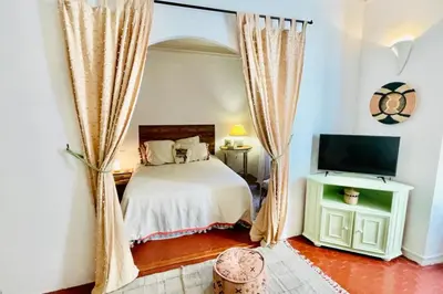 a bedroom with a bed and a flat screen tv at Great studio in the heart of Cannes Meynadier old city neighbourhood ! in Cannes
