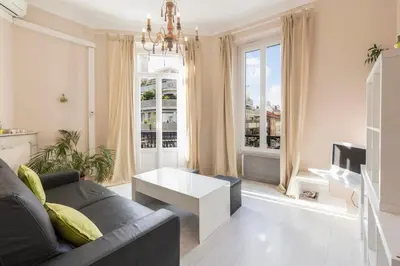 a living room with a couch and a table at Cosy apartment 39M2, two steps from rue d'Antibes and Croisette in Cannes