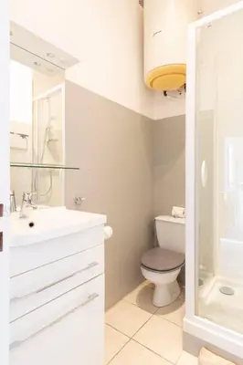 a bathroom with a toilet and a sink and a shower at Cosy apartment 39M2, two steps from rue d'Antibes and Croisette in Cannes