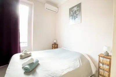 a bedroom with a bed with two stuffed animals on it at Cosy apartment 39M2, two steps from rue d'Antibes and Croisette in Cannes