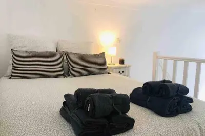 a bed with two black towels on top of it at MIPIM Rue Montaigne, 200m Palais des festivals in Cannes