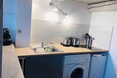 a kitchen with a sink and a washing machine at MIPIM Rue Montaigne, 200m Palais des festivals in Cannes