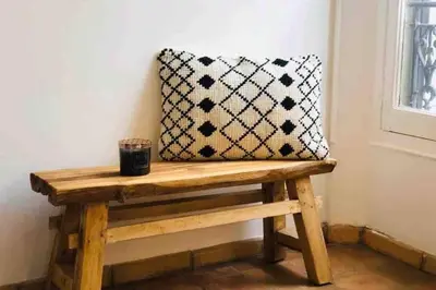 a pillow sitting on a wooden bench next to a window at MIPIM Rue Montaigne, 200m Palais des festivals in Cannes