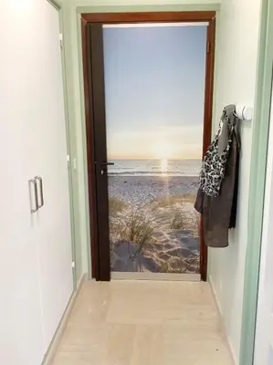 an open door with a view of the beach at Studio Mimosa Croisette in Cannes