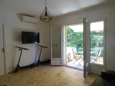 a living room with two exercise bikes and a sliding glass door at La Rotonde in Cannes