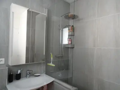 a bathroom with a sink and a shower with a mirror at La Rotonde in Cannes