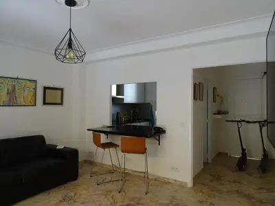 a living room with a black couch and a table at La Rotonde in Cannes