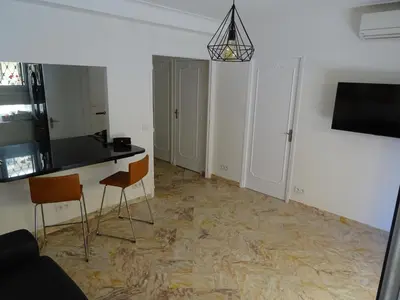 a living room with a table and two chairs at La Rotonde in Cannes