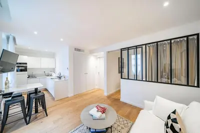 a living room with a white couch and a table at Luxury Apartment 100 m to Palais des Festivals in Cannes