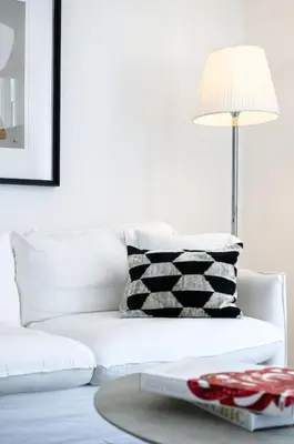 a living room with a white couch and a table with a lamp at Luxury Apartment 100 m to Palais des Festivals in Cannes