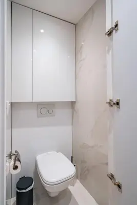 a white bathroom with a toilet and a shower at Luxury Apartment 100 m to Palais des Festivals in Cannes