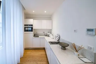a kitchen with white cabinets and a counter top at Luxury Apartment 100 m to Palais des Festivals in Cannes