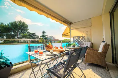 a balcony with a table with food on it at Le Prado Parc in Cannes