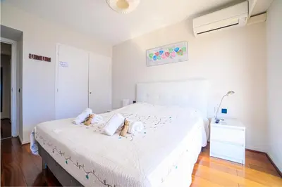 a bedroom with a bed with two teddy bears on it at Le Prado Parc in Cannes