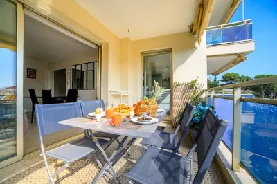 a table and chairs on the balcony of a house at Le Prado Parc in Cannes