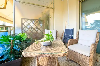 a table and chairs on a porch with plants at Le Prado Parc in Cannes