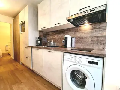 a kitchen with a washer and dryer in it at Appartement 0321, piscine - parking - proche plages - Palmazur Vacances in Cannes