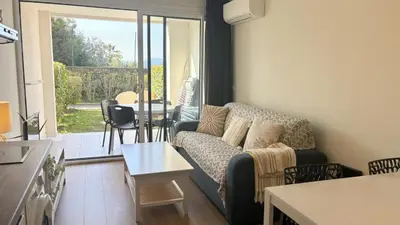 a living room with a couch and a table at Appartement 0321, piscine - parking - proche plages - Palmazur Vacances in Cannes