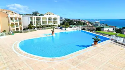 a large blue swimming pool on top of a building at Appartement 0321, piscine - parking - proche plages - Palmazur Vacances in Cannes