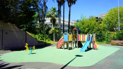 a playground in a park with children playing on it at Appartement 0321, piscine - parking - proche plages - Palmazur Vacances in Cannes