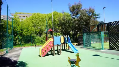 a playground with a slide in a park at Appartement 0321, piscine - parking - proche plages - Palmazur Vacances in Cannes