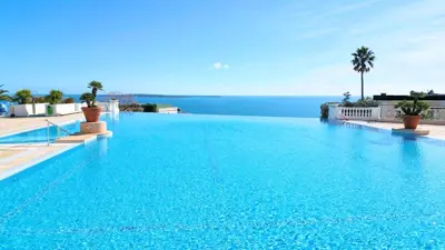 a large swimming pool with a view of the ocean at Appartement 0321, piscine - parking - proche plages - Palmazur Vacances in Cannes