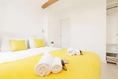 a bedroom with a large bed with towels on it at Great Sea View YourHostHelper in Cannes